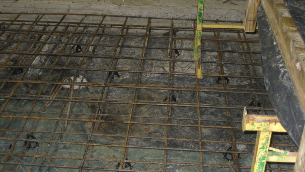 Basement slab reinforcement and waterproofing membrane